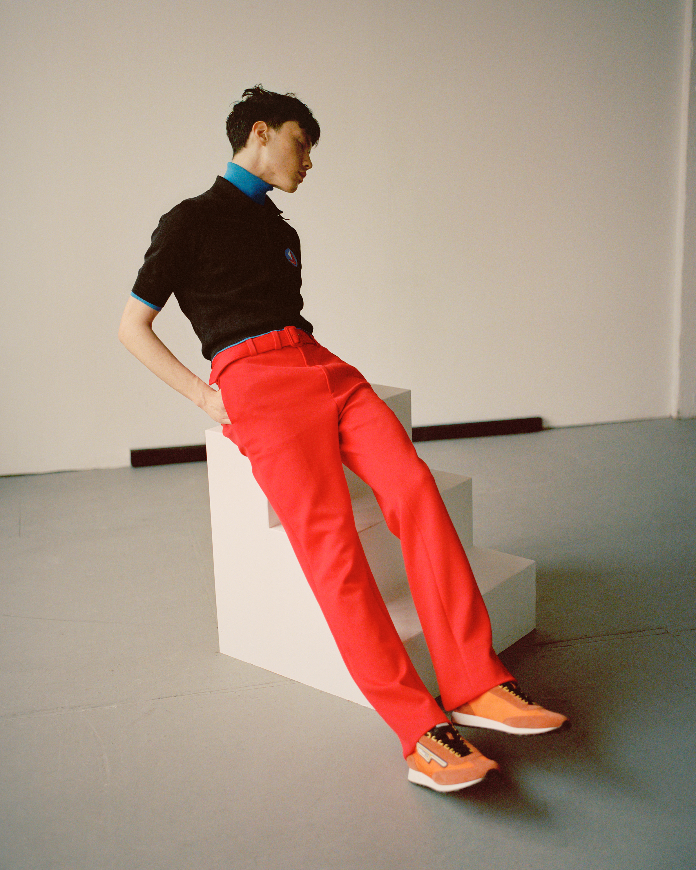  Prada (FULL LOOK) Technical jersey trousers, Cotton jacquard polo shirt, Cotton jacquard turtleneck sweater, Suede and nylon sneakers