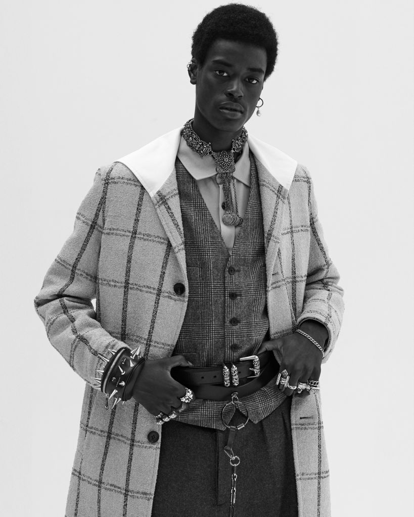  Babacar wears coat Lanvin Shirt and pants Holland & Holland Vest Brooks Brothers Belt (top), earring (his right), rings (right index, ring, pinky fingers and left pinky finger, bottom) Chrome Hearts Wristband Givenchy Ring (left index finger) Alexander McQueen Ring (left middle finger) Ambush Necklace (throughout) stylist’s own Rings (left ring finger and pinky, top) model’s own
