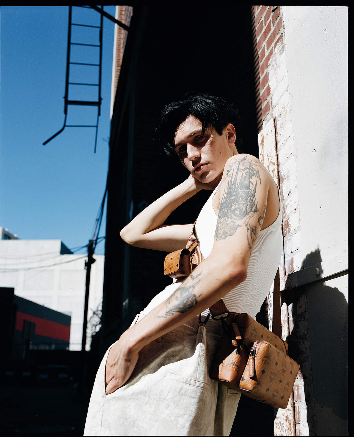  Huddy wears pants Our Legacy, bag MCM, tank top stylist’s own, on hair OUAI Matte Pomade